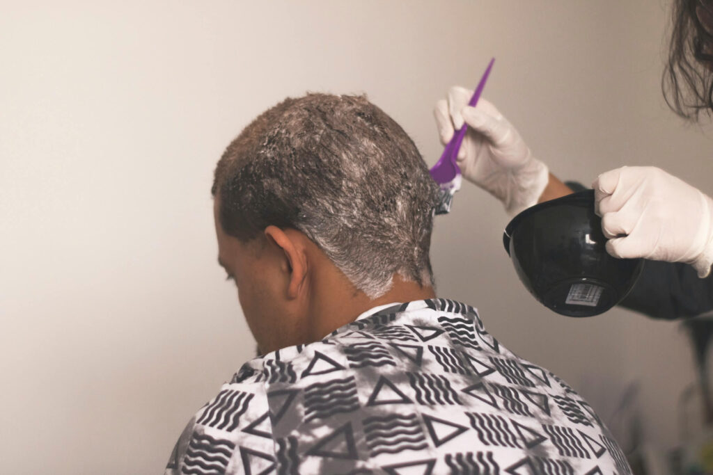 man getting his hair colored in a salon