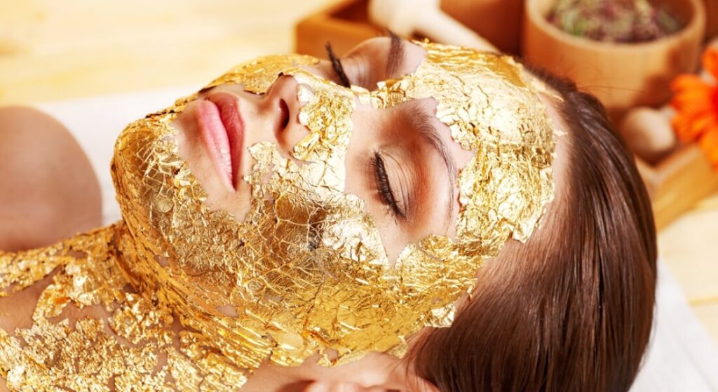 woman wearing a gold face mask