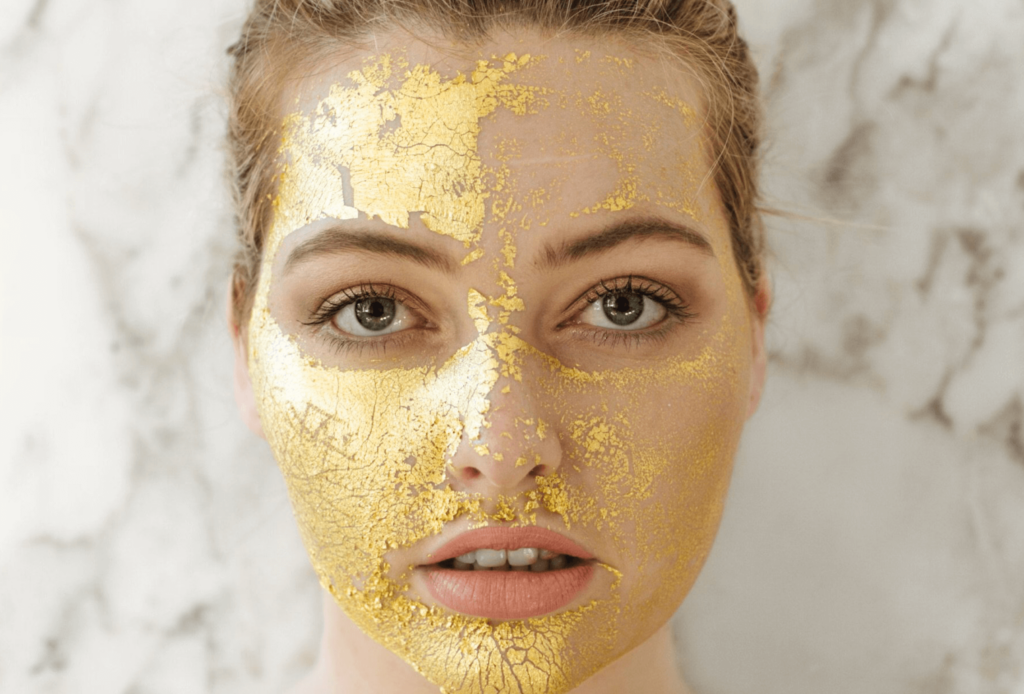 woman wearing a gold face mask