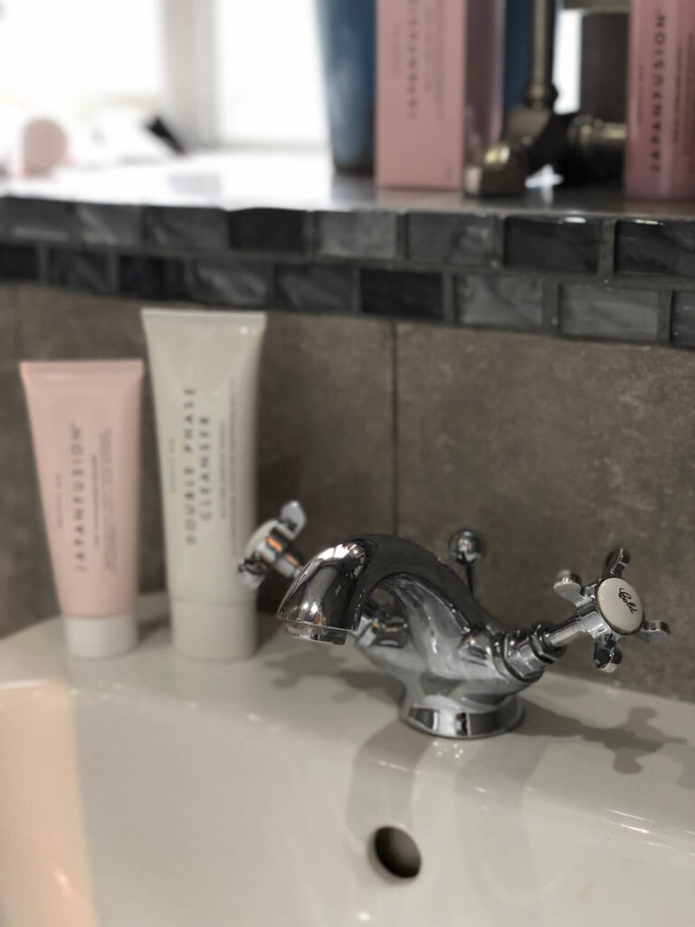 sink with acne products on the edge