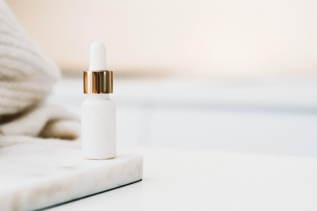 White beauty bottle on a marble countertop