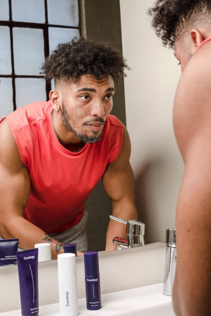 man washing his face in front of a mirror gluten free beauty products 