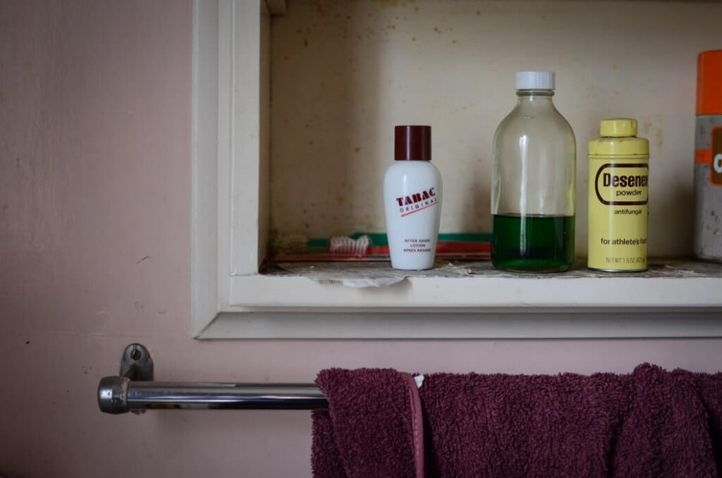 bottles of skincare and a toothbrush on a shelf gluten free beauty products 