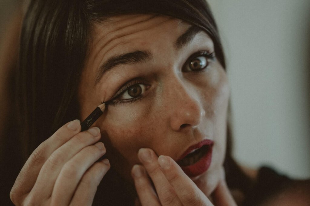 woman applying black eyeliner