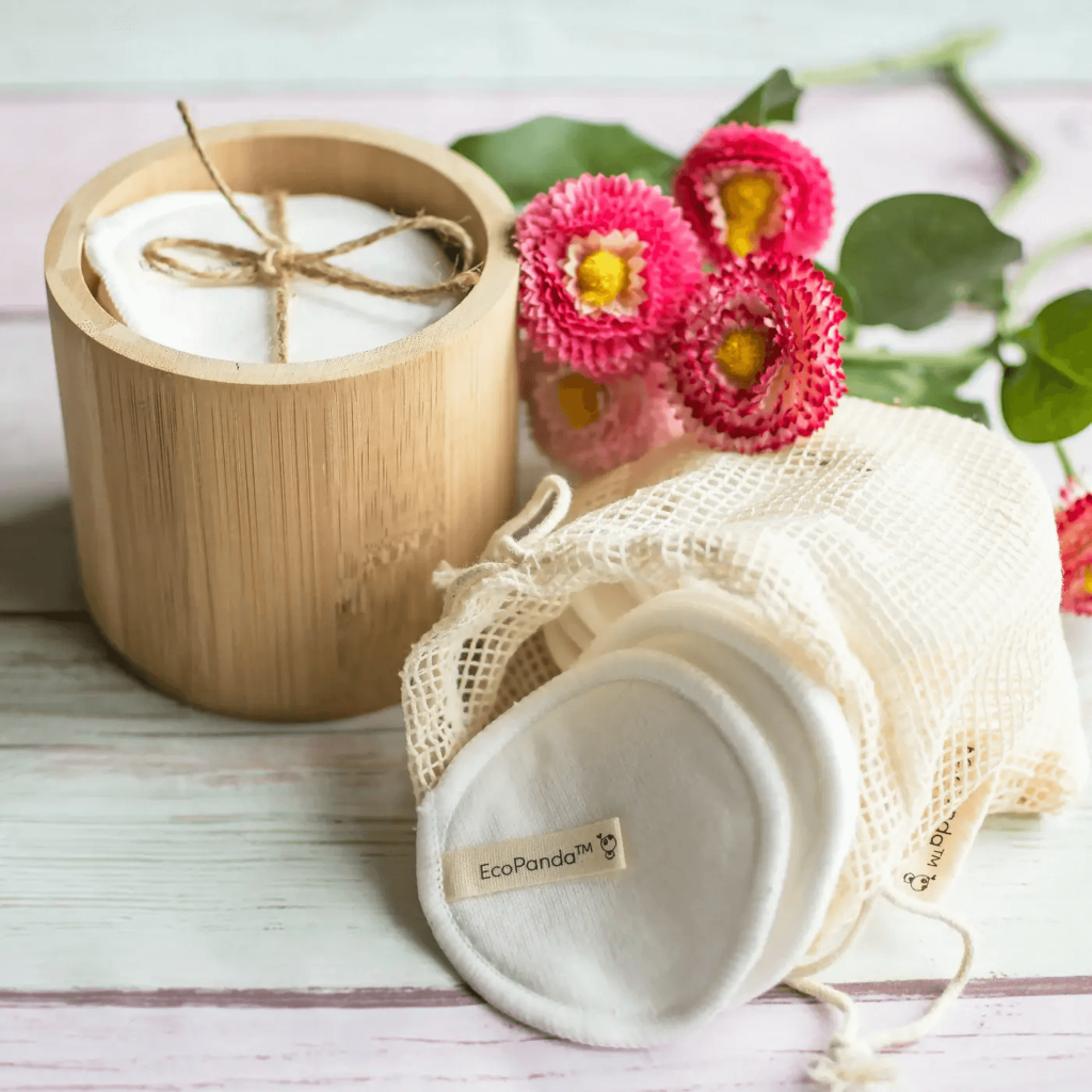 eco panda reusable cotton rounds inside a bamboo cylinder and a pouch