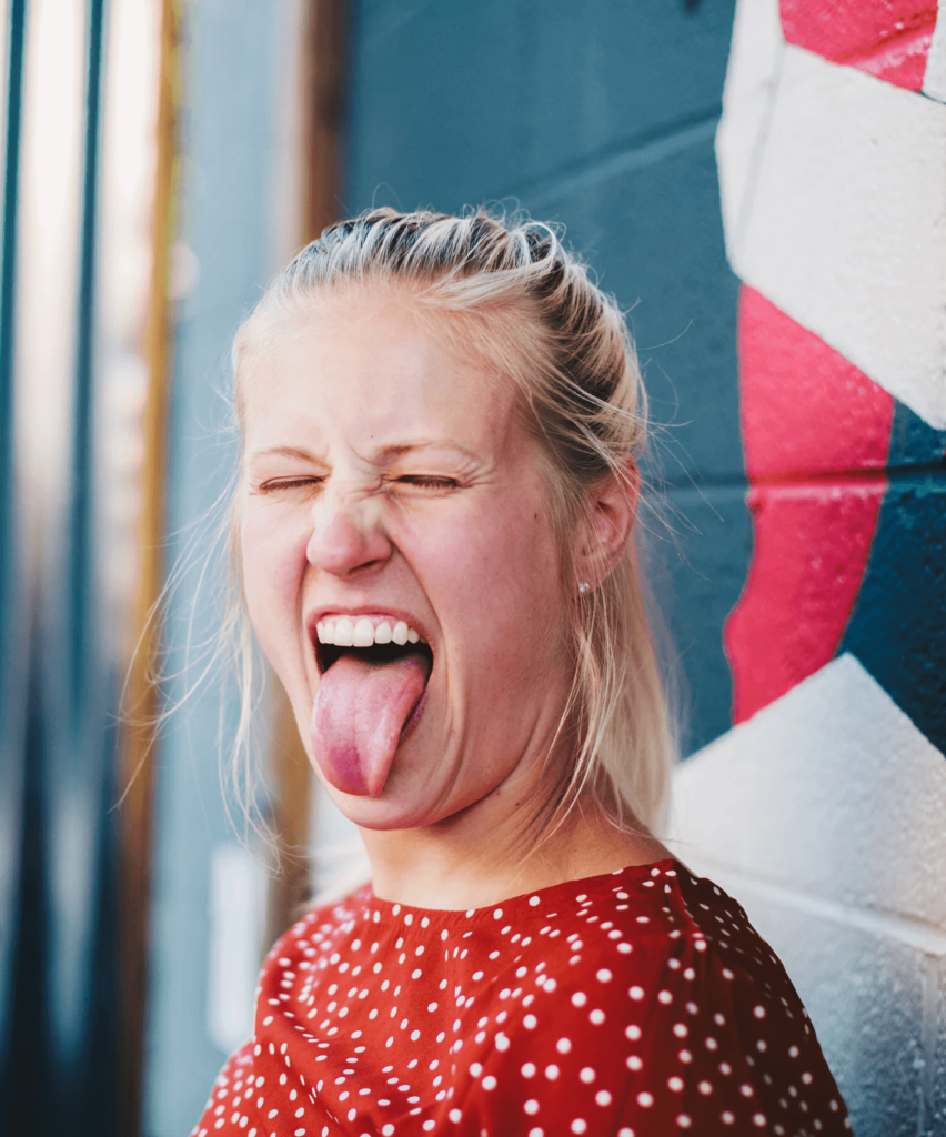 a young woman showing her tongue out