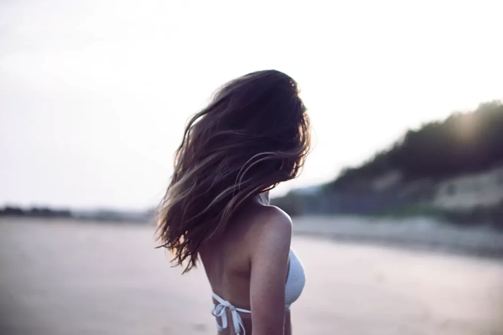 a woman in a bikini facing backwards