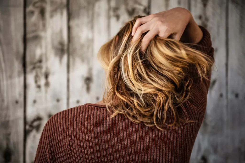 woman running hands through her hair