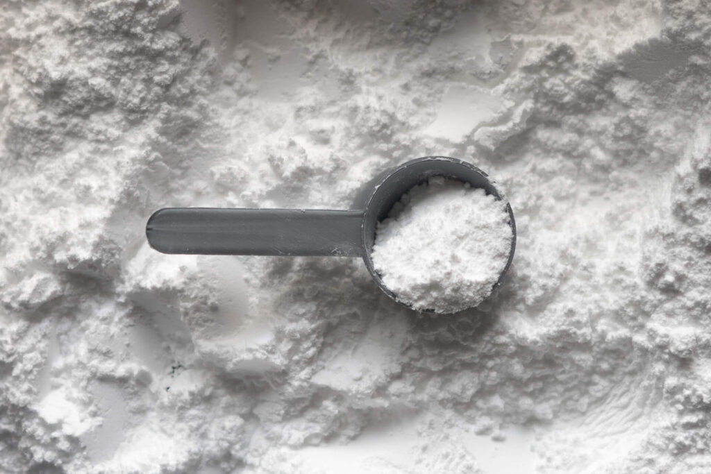 flat lay of black scoop on white powder