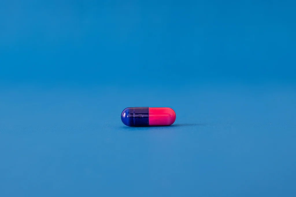 red and blue pill on a blue surface