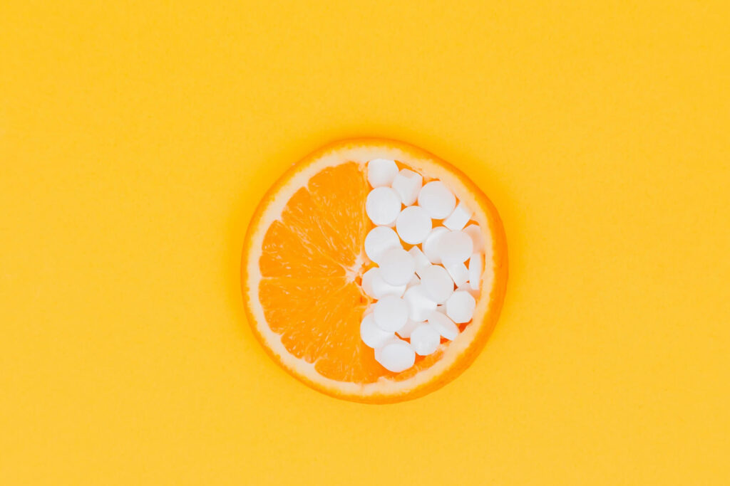 a piece of orange and pills
