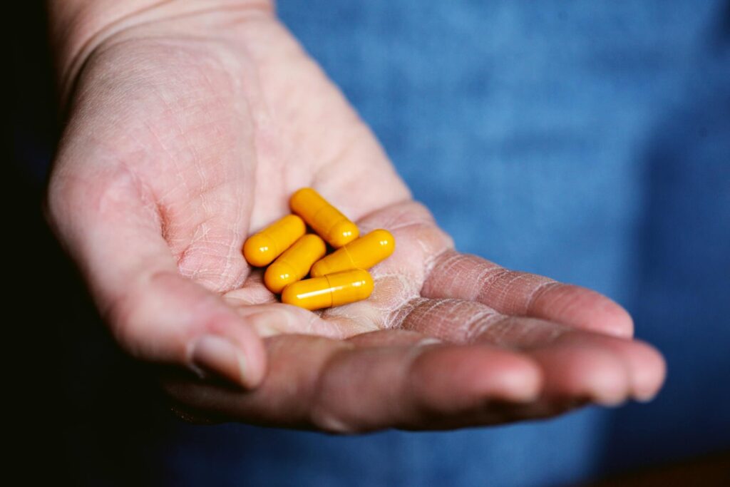 yellow pills on a hand