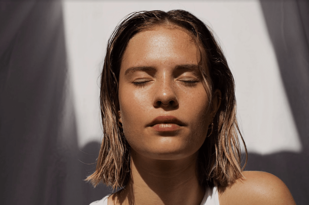 Photo of a woman with eyes closed and short brown hair