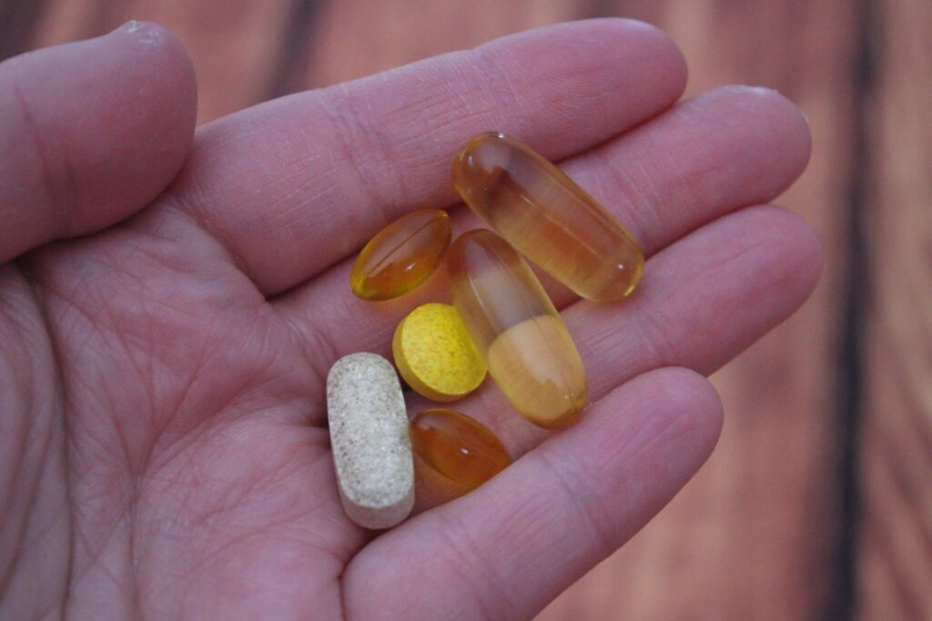 medicine tablets and softgels on hand