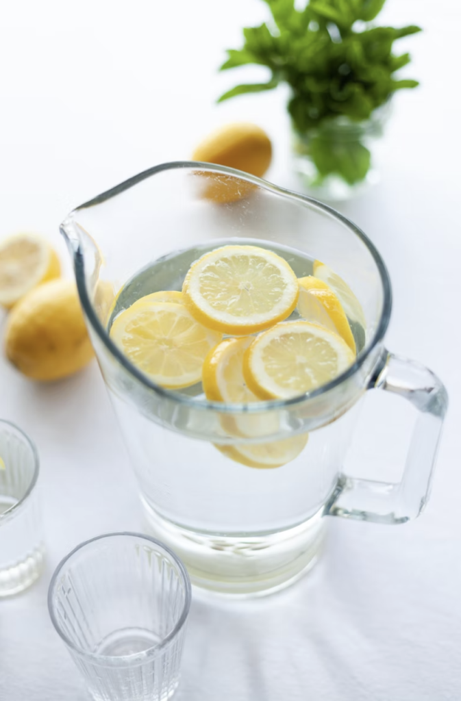 glass pitcher of lemon water Benefits of Drinking Water for Skin