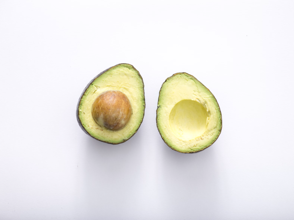 avocado sliced in half natural ingredients for hair