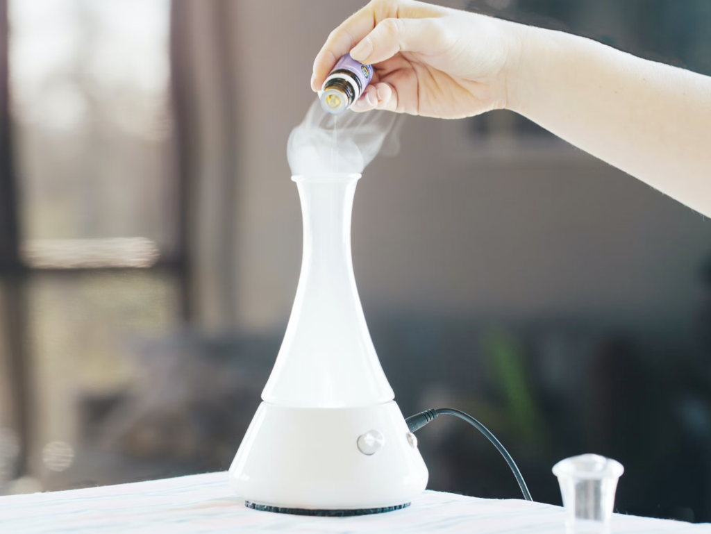 a person filling up a diffuser with essential oil